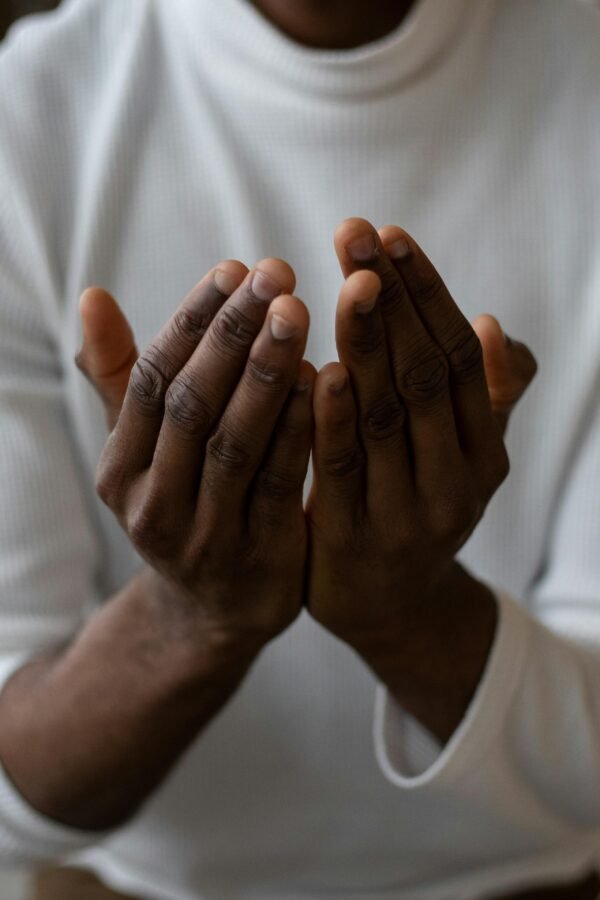 Image of black man holding his hands in a supplicating way.