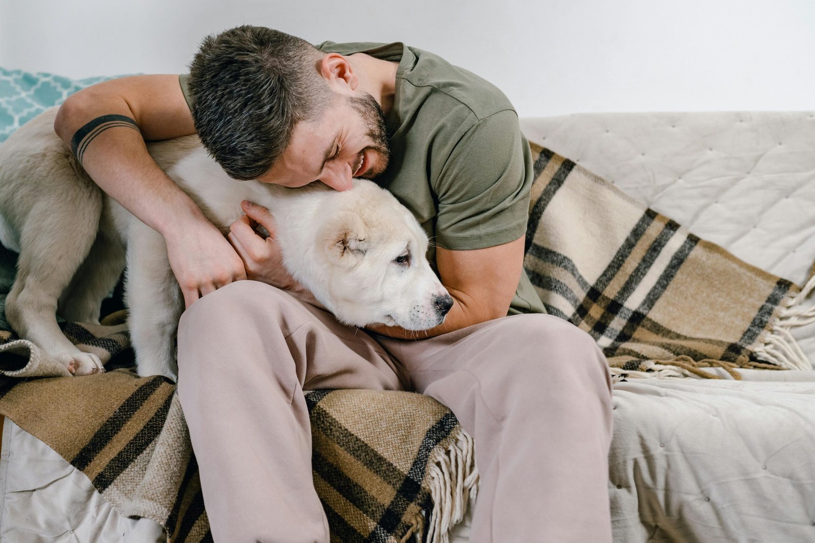 Young man holding older dog