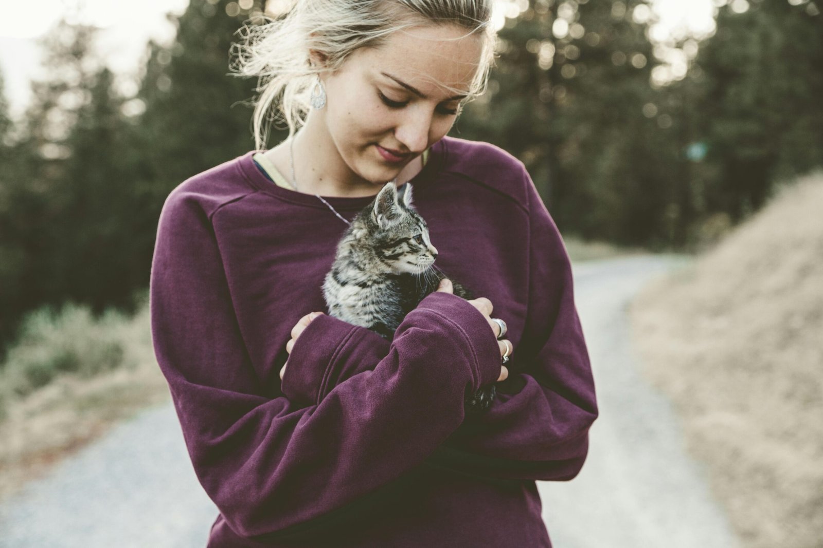 young woman holding cat for comfort