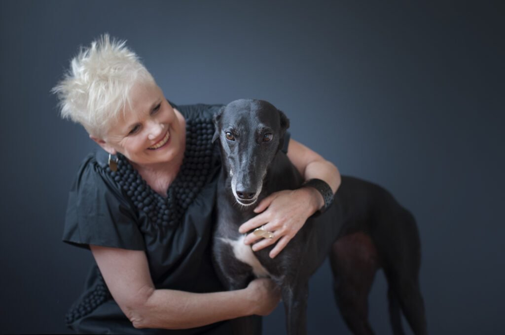Noelene cuddling her dog Issy - the epitome of a calm companion